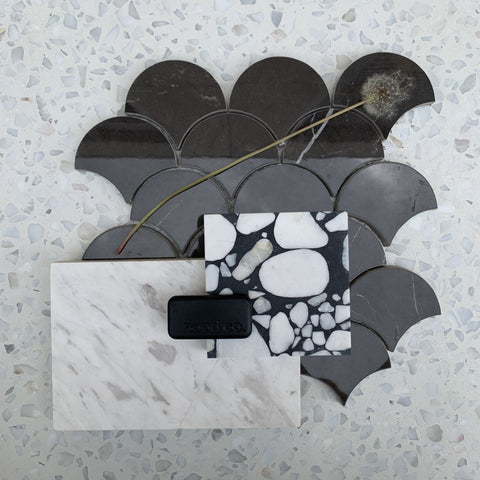 a flat lay mood board with black, grey and white tiles