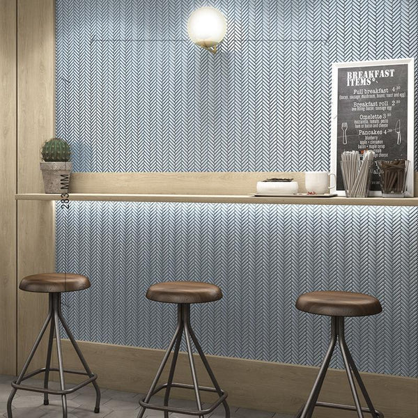 restaurant with three brown stools and blue kitkat porcelain tiles on the wall