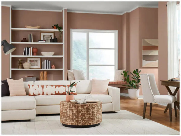 A lively living room design with Redend Point colour. There is a book shelf, some couches and coffee table.