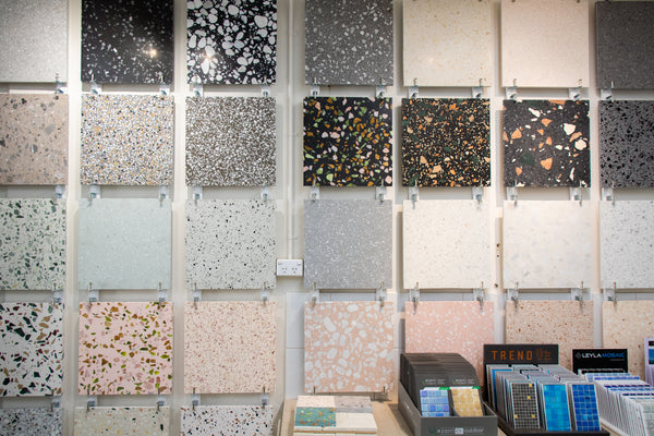 a wall with terrazzo tile samples in Stone and Tile Projects showroom