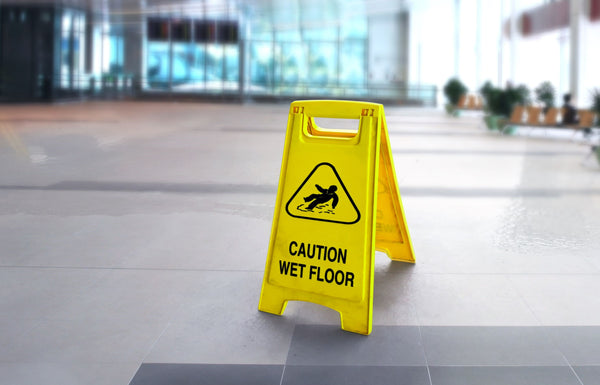 a yellow sign with the words "Caution Wet Floor"
