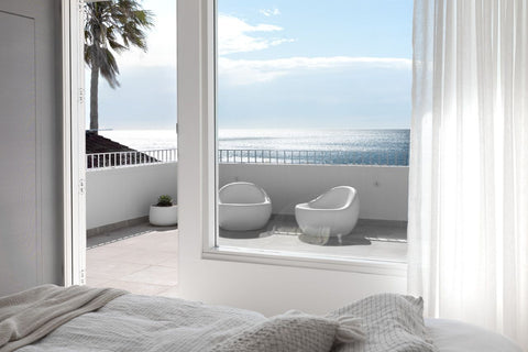 minimalist and modern looking balcony with marble flooring and a view of the ocean in NSW, Australia