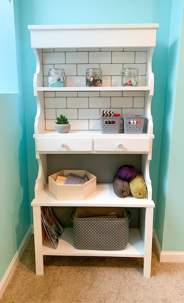 a DIY bookcase with leftover white colour tiles 