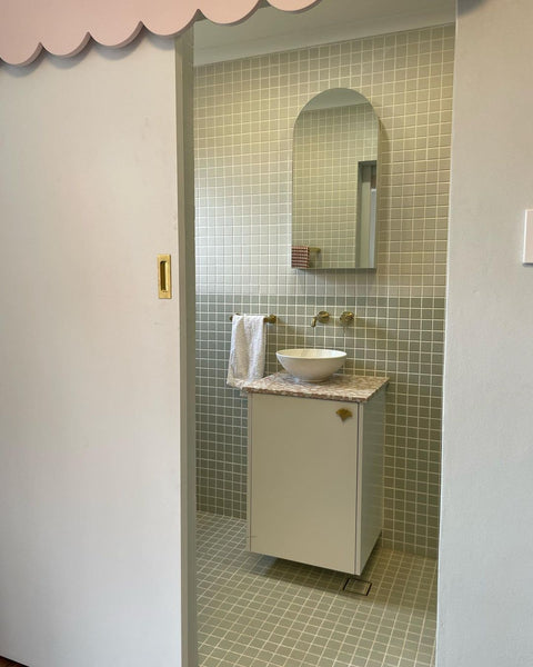 a bathroom renovation with green porcelain mosaic tiles 