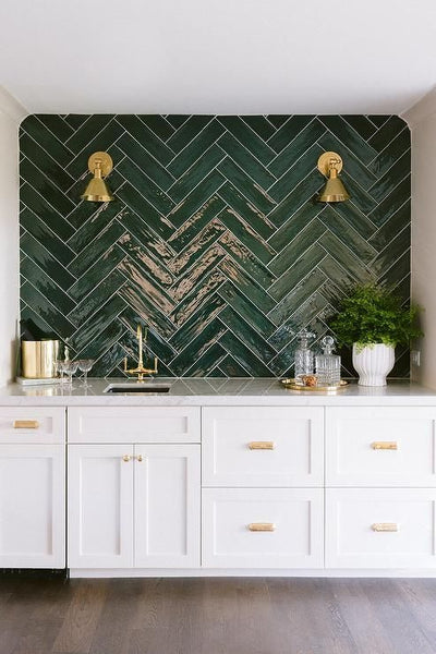 kitchen splashback with green subway tiles laid with herringbone pattern