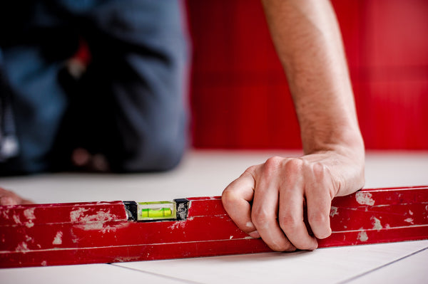 a man using a level on the floor