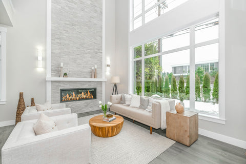 living room with grey floors and creamy colour couches.