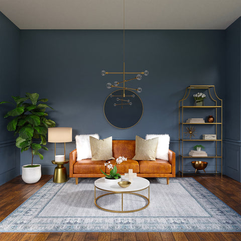 a living room with blue walls and brown sofa