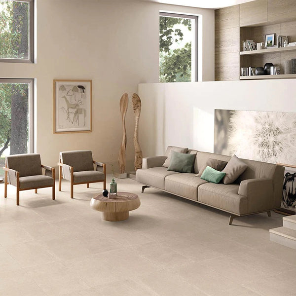 beige limestone flooring in a living room with light brown couches.