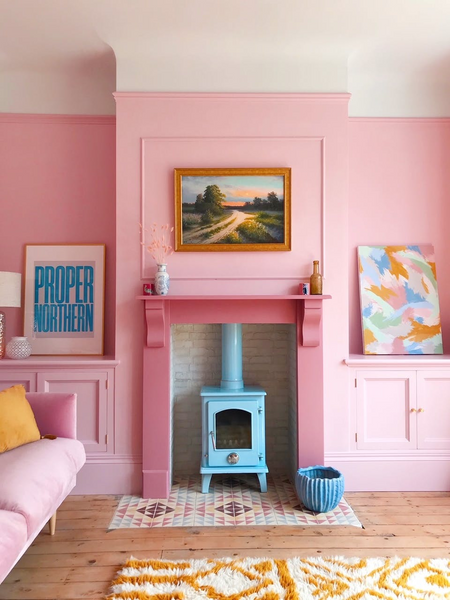 sleek and modern style interior design with bright pink and yellow colour and a fireplace