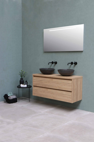 a bathroom with blue tiles on the walls and white flooring tiles.