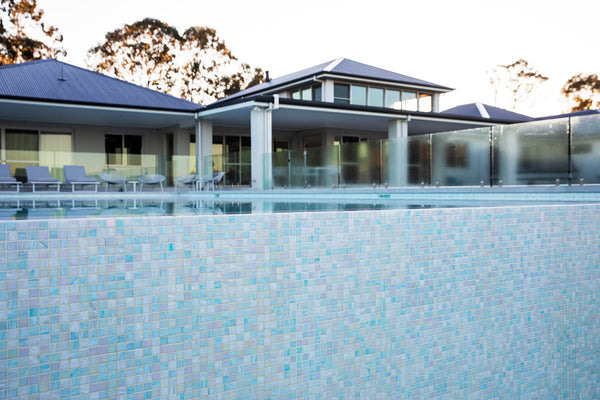 blue glass mosaic tiles in an outdoor swimming pool