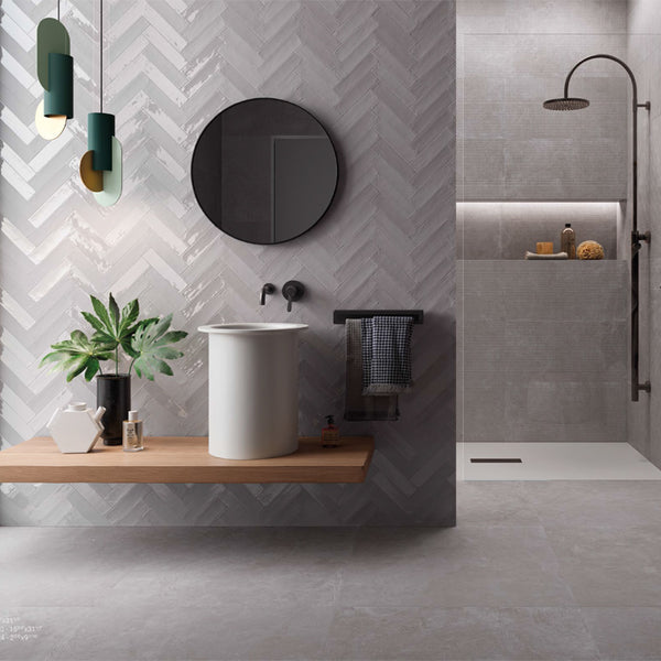 spacious bathroom with white subway tiles laid in herringbone pattern