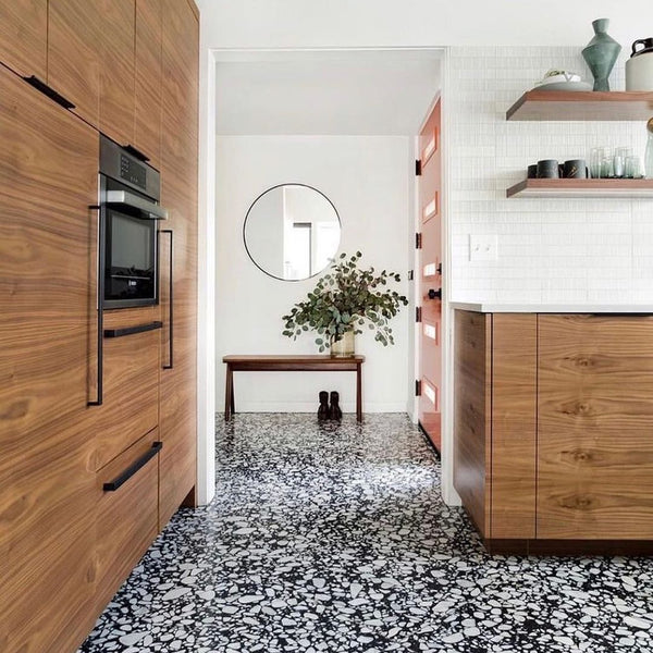 kitchen with black and white terrazzo tiles and brown cupboards