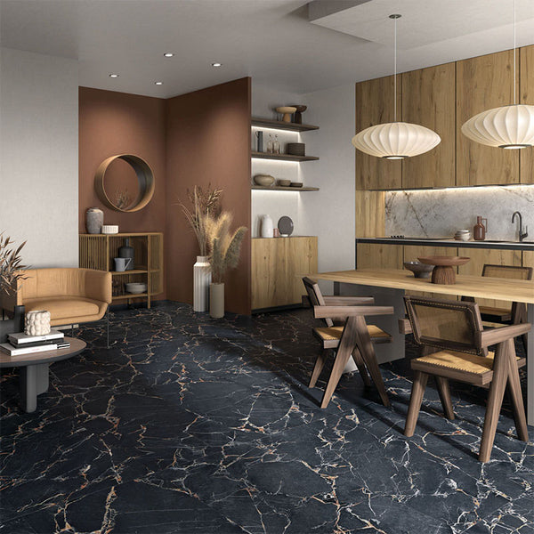 A living room with black marble-look porcelain tiles with gold veining on the floor.