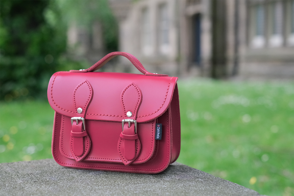 Zatchels pink classic satchel placed on wall