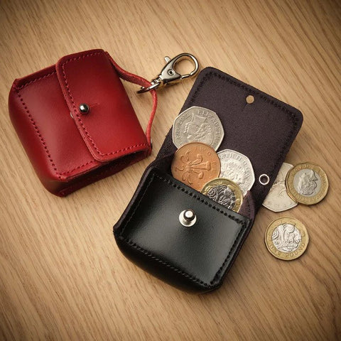 mini coin purse handbag charm in red and black with coins on a wooden background