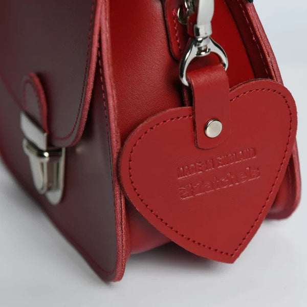 close up of red heart charm attached to red bag