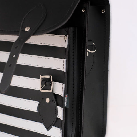 close up of front compartment on black and white striped backpack