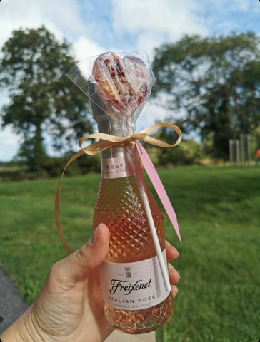 Heart rose petal lollipop tied with a ribbon onto a mini bottle of fizz