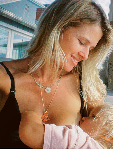 Sarah Wright Olsen breastfeeding her child