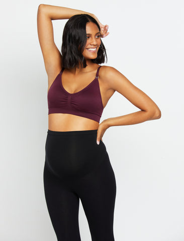 Woman smiling wearing seamless maternity bra and leggings