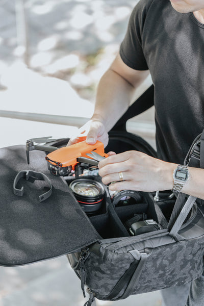 Photographer works with drone on top of the top shelf