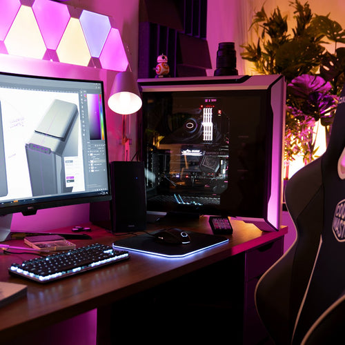 Picture of pro level gaming setup with products from CoolerMaster, including PC Case, Keyboard, mouse and Gaming Surface. RGB lighting and plants in the background.