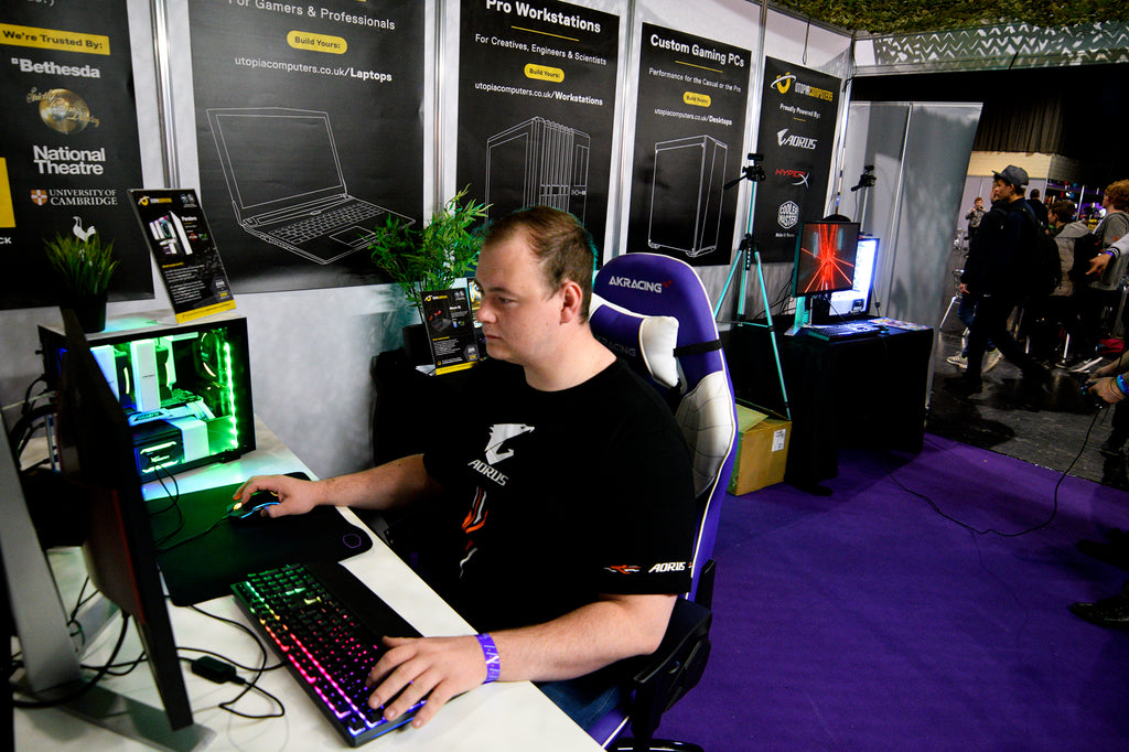 PC Gamer playing on a custom gaming PC from Utopia Computers at an expo