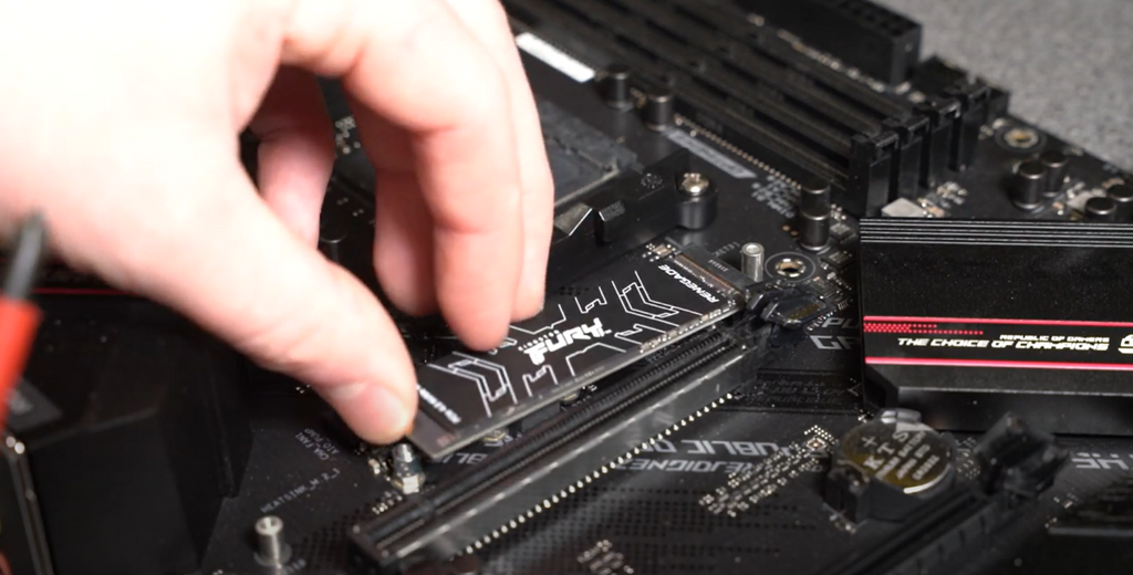 Kingston Fury M.2 being installed in motherboard