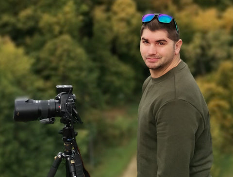 Hristo Bakrachev photographer next to his photo camera Canon in the mountains