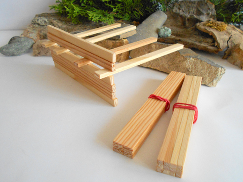 Mini lumber beams and boards pictured how they are used to create a structure 
