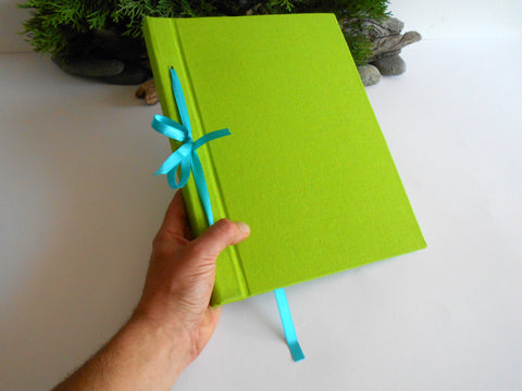 Handmade eco-friendly and refillabl sketchbook with light green fabric hardcovers by ExiArts