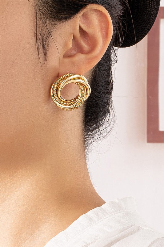 Three pairs of intertwined hoop stud earrings