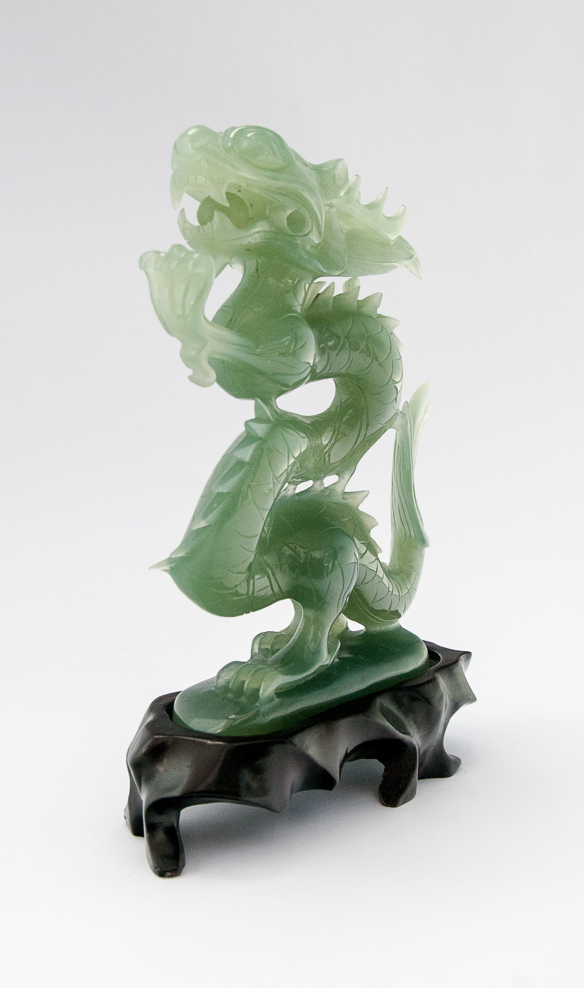 A superb carved green jade Dragon with loose carved ball in its mouth ...