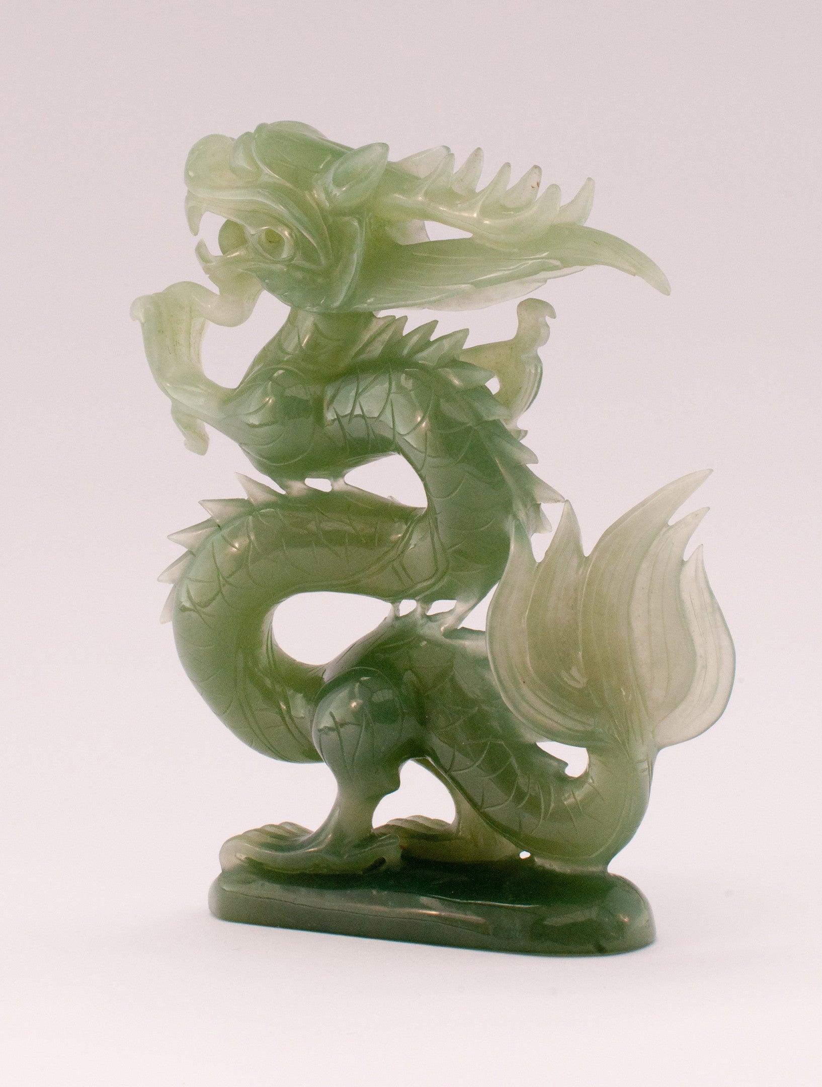 A superb carved green jade Dragon with loose carved ball in its mouth ...