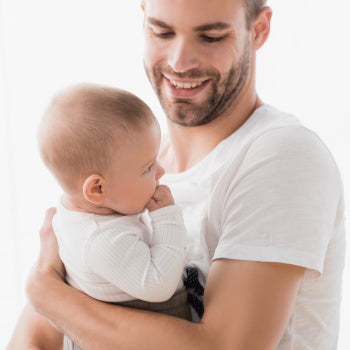 Dad holding 1 month old baby