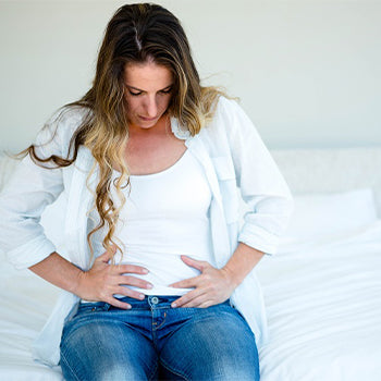 Woman experiencing 2 Months Pregnant Symptoms