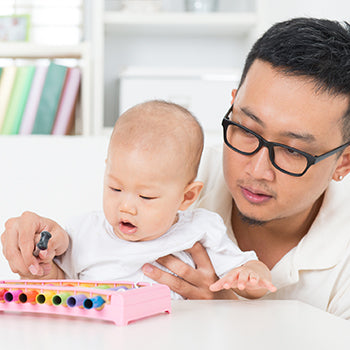 Dad playing with 6 month old baby