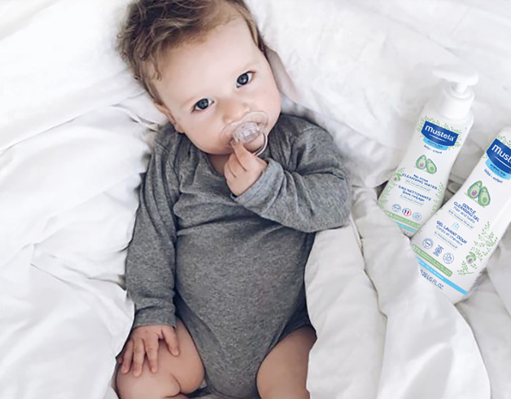 baby laying on back with a pacifier