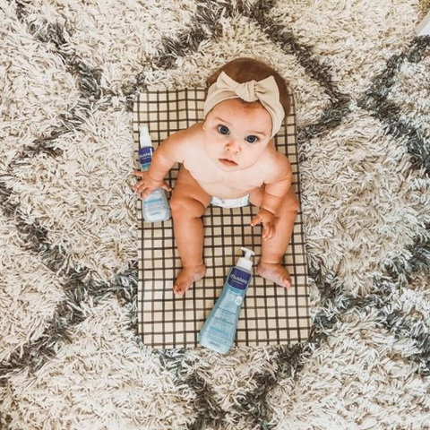 baby sitting on rug