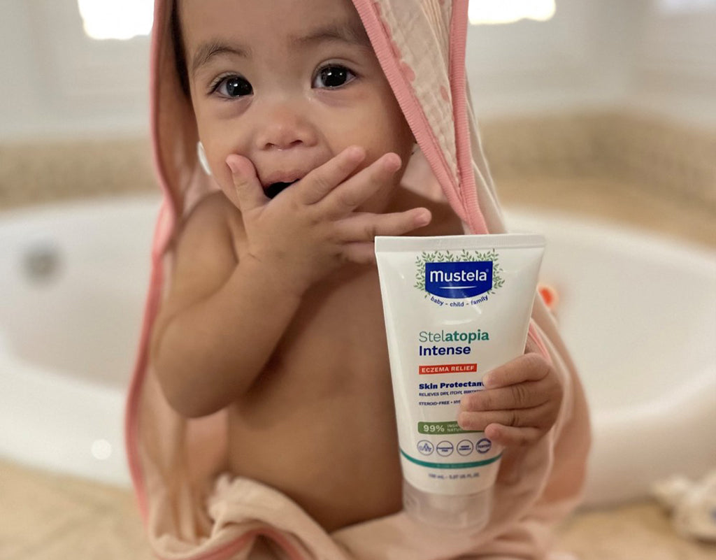 Baby holding Stelatopia intense cream