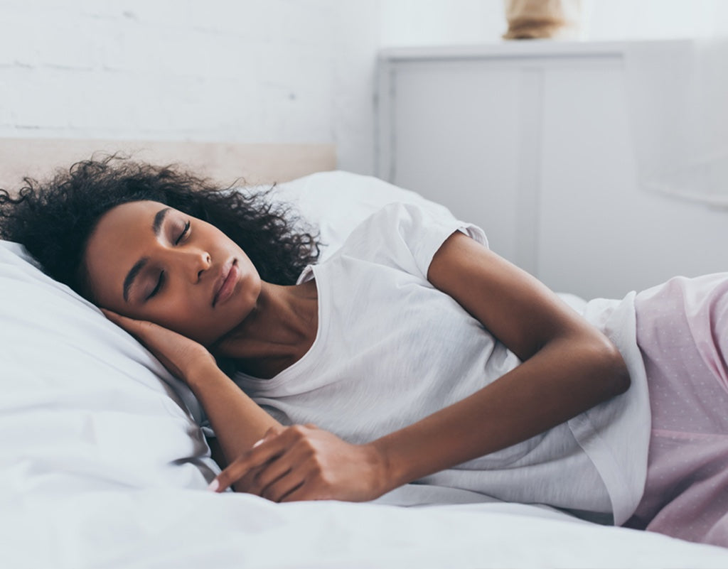 Mom getting a good night sleep because she dream feeds her baby