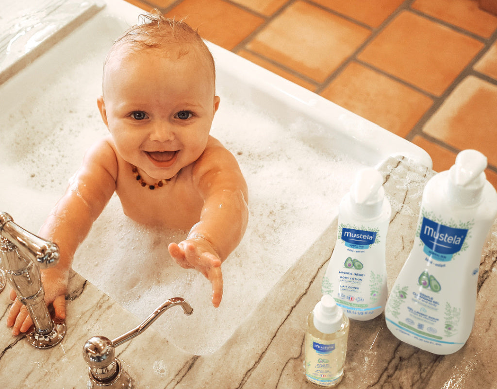 Baby in the bath with Mustela's products