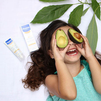 Young girl playing with avacados