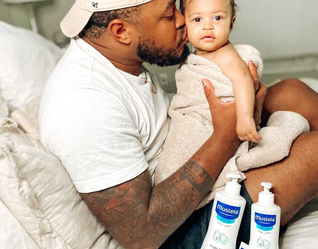 dad kissing baby who uses avocado benefits for skin