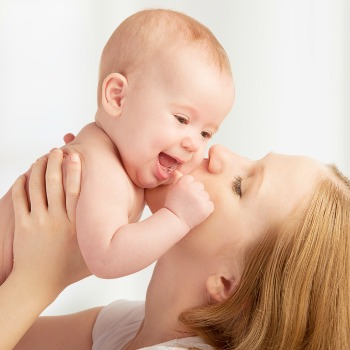 Mom kissing baby's cheeck