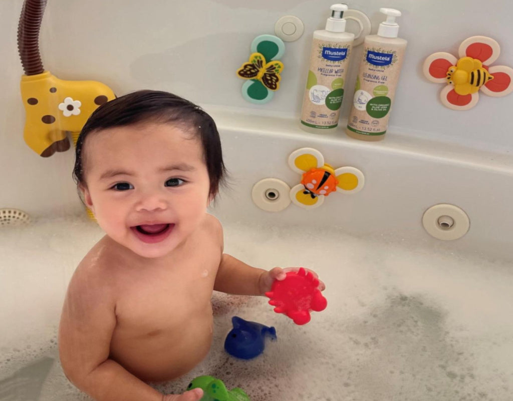 baby bathing with toys