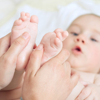 Parent playing with baby feet