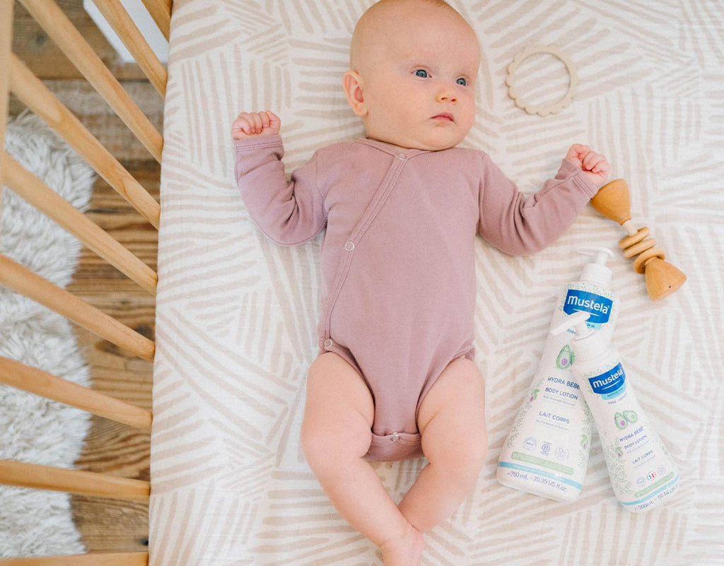 baby laying down on back in crib